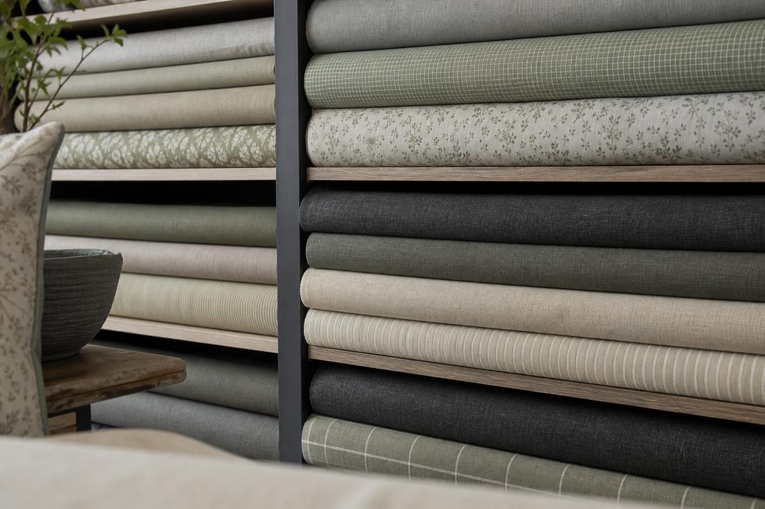 Stacked fabric bolts in a soft furnishings shop